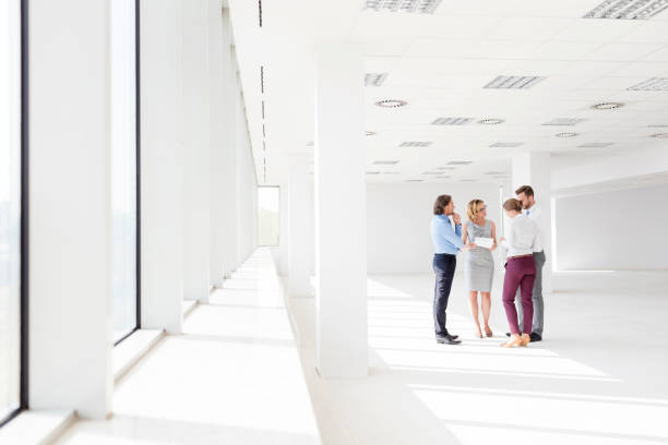istock Business colleagues discussing during meeting while standing in new office 1152541002
