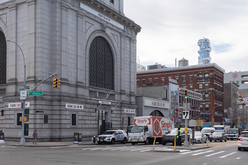 New York City, USA - Feb. 26, 2019: Intersection of Bowery and Canal street in Chinatown, with cars and pedestrians walking, and HSBC Bank