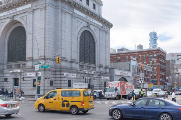 New York City, USA - Feb. 26, 2019: Intersection of Bowery and Canal street in Chinatown, with cars and pedestrians walking, and HSBC Bank