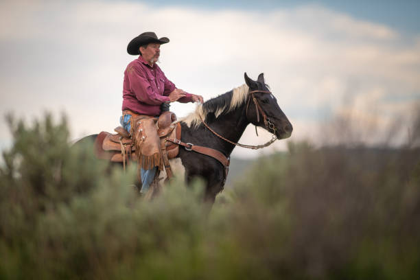 istock Senior cowboy horseback riding 1152545511
