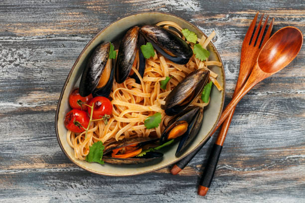 istock Pasta Mussels with herbs and tomatoes in a bowl 1152545520