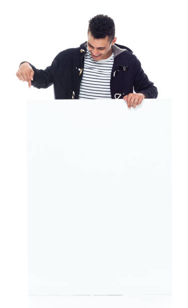 istock Tall good looking black man wearing a warm jacket - pointing 1152547579