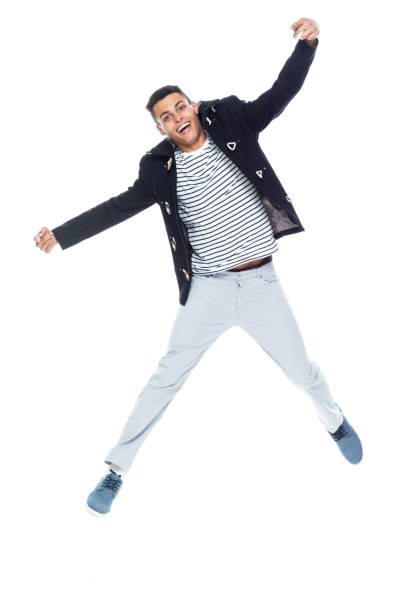 istock Very handsome tall black man dressed in trendy clothes - jumping and pointing forward 1152547707