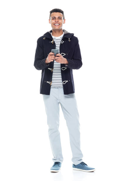 istock Handsome tall black man wearing a jacket on white background - holding smart phone 1152547711
