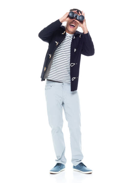 istock Handsome black man with curly hair and wearing a jacket - binoculars 1152547733