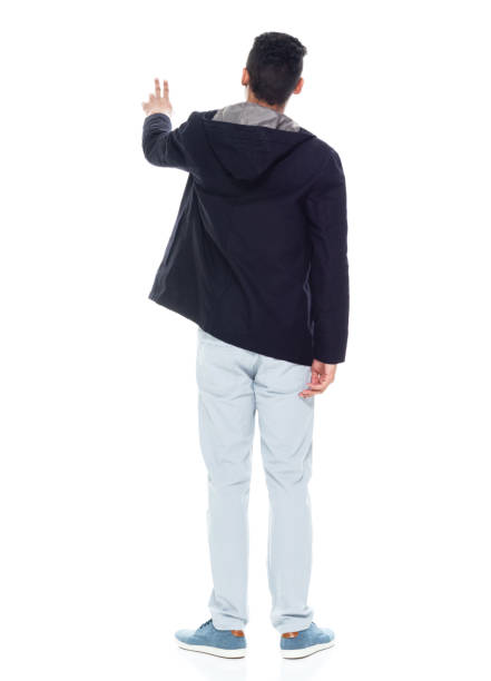 istock Very handsome tall black man wearing a warm jacket - rear view, pointing / touching 1152547821