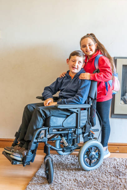 istock Young carer with boy in wheelchair 1152551700