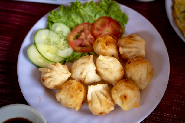 istock Fried dumplings stuffed with meat and served with chopped parsley and spring onion. 1152551948