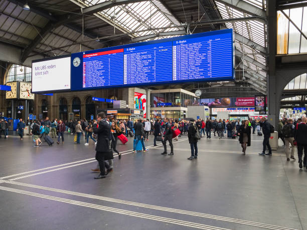 Hall of the Zurich main railway station Zurich, Switzerland - May 29, 2019: people and arrival/departure board in the hall of the Zurich main station. Zurich main station is the largest railway station in Switzerland. zurich train station stock pictures, royalty-free photos & images