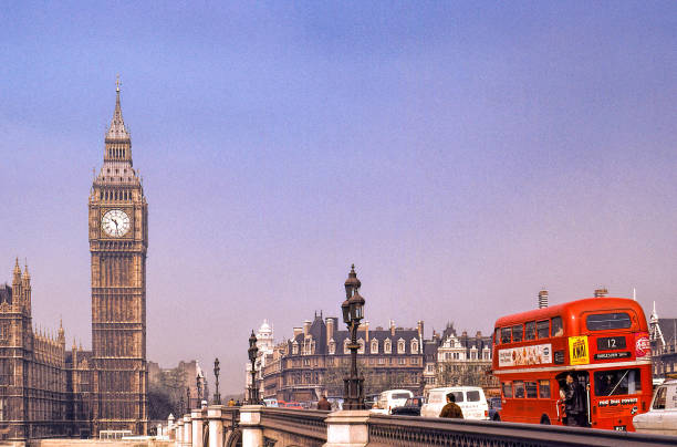 Nostalgi. Big Ben and double decker., London 1973.. 
The red double decker is passing over a bridge towards Houses of parliament and Big Ben in the background. More cars nd pedestriana on the bridgege. Clear sky with some haze.

+++ scanned slide from 1973 +++