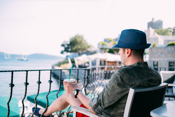 istock Urban Man Drinking Coffee in Coast Cafe 1152560882