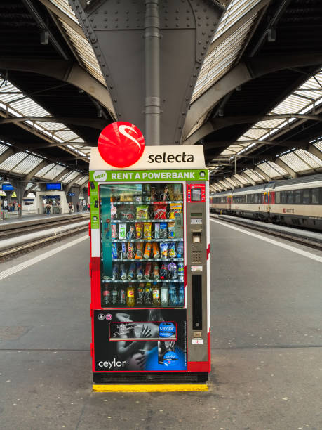 A vending machine on a platform of the Zurich main railway station Zurich, Switzerland - May 29, 2019: a vending machine on a platform of the Zurich main railway station, people on another platform in the background. Zurich main station is the largest railway station in Switzerland. zurich train station stock pictures, royalty-free photos & images