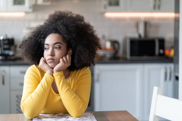 istock Depressed afro woman at home 1152561023