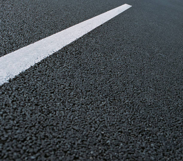 istock White dotted line on city asphalt road background 1152564828