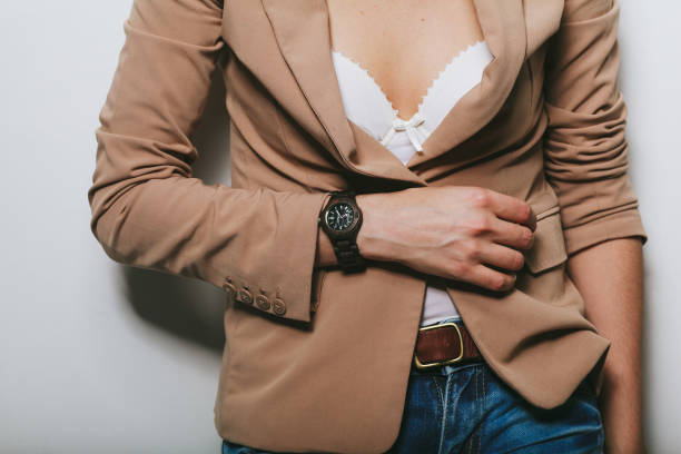 istock The girl in a jacket with a clock on her hand 1152564855