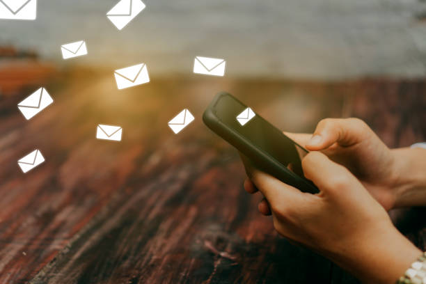 istock Woman hand using smartphone and it's show email recieve notification icon pop up on screen of mobile phone. Business communication  technology concept. 1152565784