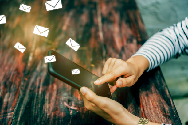 istock Woman hand using smartphone and it's show email recieve notification icon pop up on screen of mobile phone. Business communication  technology concept. 1152565803