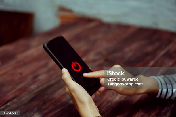 Woman Hand Using Smartphone To Switch Off Or Shut Down Online And Social Connection Business Financial Trade Stock Maket And Social Network Concept Stock Photo - Download Image Now