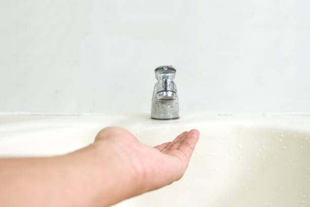 istock Faucet with man's hand. In the bathroom. 1152567437
