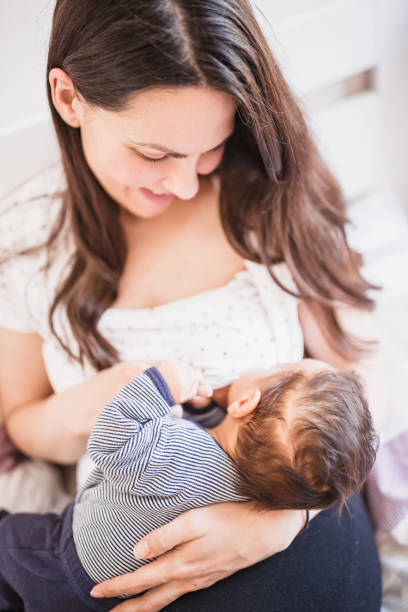 istock Mother is breastfeeding her son while lying in bed. 1152567729