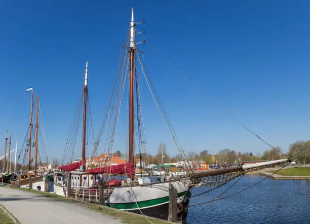 Old sailing ships at the quay of Ryck river in Greifswald, Germany