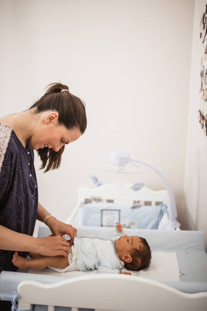 istock Mother changing a her baby's diaper 1152567814