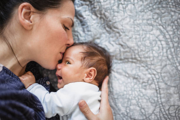 istock Smiling mother with her newborn son in bed 1152567838
