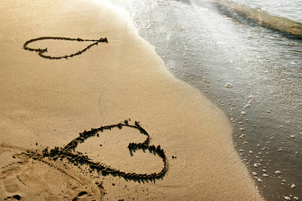 istock close up heart shape on sandy beach 1152567843
