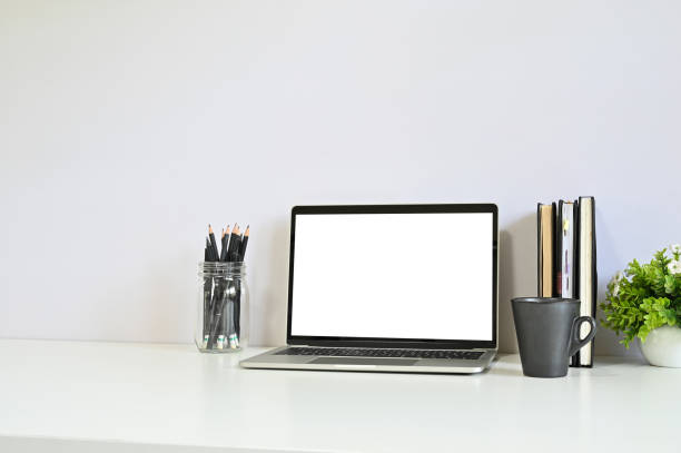 istock Workspace laptop, coffee, pencil and notebook on office table with copy space. 1152568764