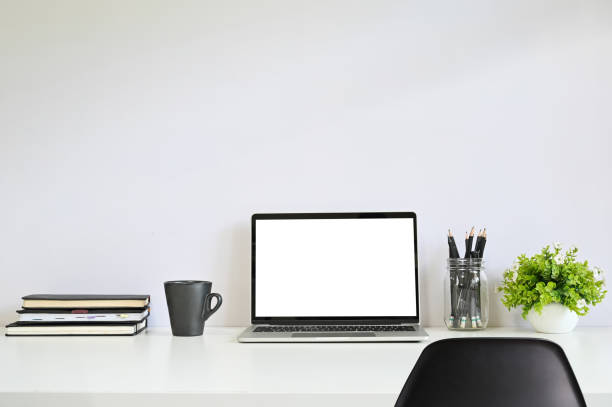 istock Laptop computer on workspace with chair, coffee, notebook paper and pencil. 1152568800