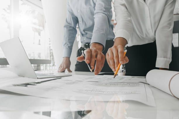 istock Architects working and meeting with blueprint on table. 1152569103
