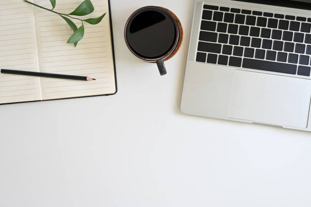istock Office desk top view table with laptop, coffee, plant, notebook and pencil 1152569108