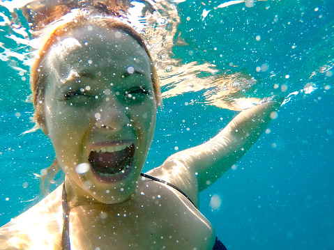Excited Young Woman Enjoying Underwater Life.