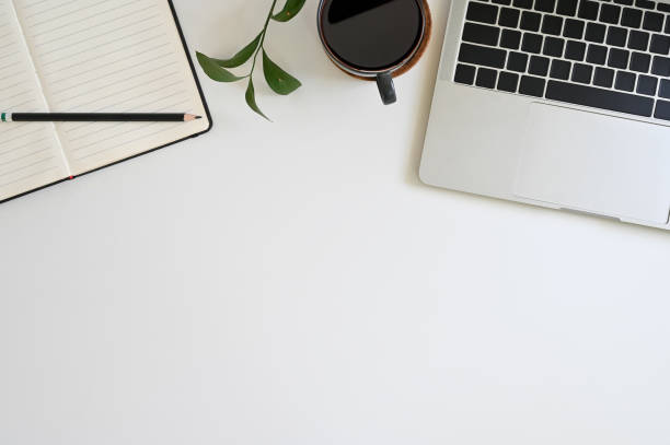 istock Office desk top view table with laptop, coffee, plant, notebook and pencil 1152569176