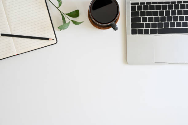 istock Office desk top view table with laptop, coffee, plant, notebook and pencil 1152569199