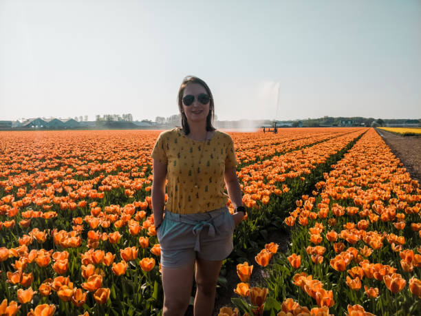 istock Woman between the orange flower fields in the Netherlands 1152570096