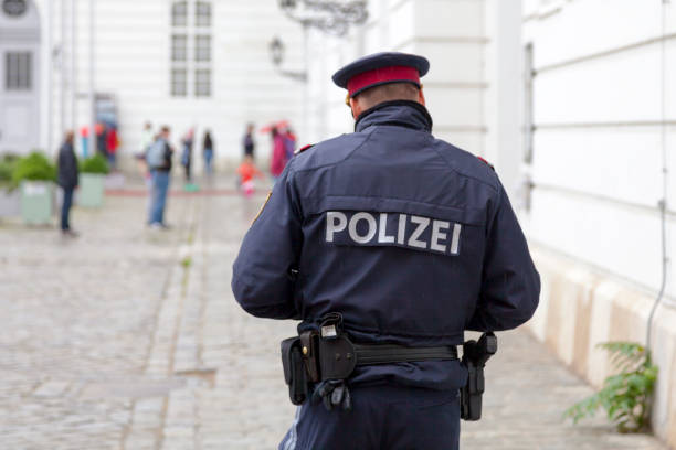 Vienna, Austria - May 29 2019: Policeman doing his patrol on Josefsplatz opposite the Austrian National Library in the city center of the capital.