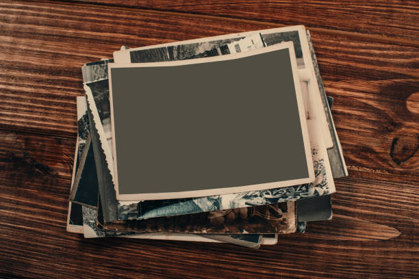 istock Stack old photos on table. Mock-up blank paper. Postcard rumpled and dirty vintage. Retro card 1152571589