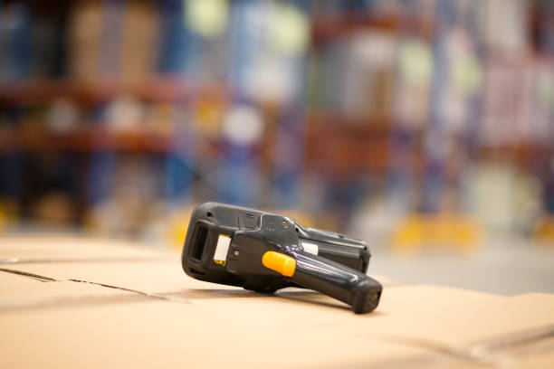 istock Close up view of barcode scanner placed on cardboard boxes in large distribution warehouse facility. Logistics and distribution concept. 1152572988