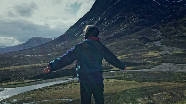 istock Embracing nature - woman enjoying view with opened arms 1152573472