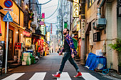 Portrait of man walking on zebra crossing on Tokyo street