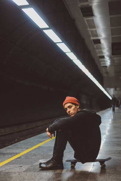 istock Young man skateboarder waiting on a train 1152577206