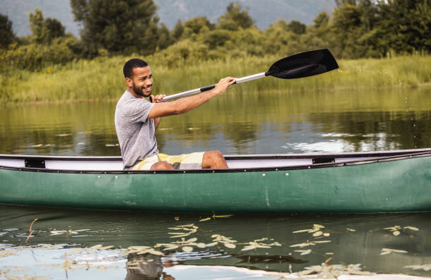 istock Young Man Canoening on the Lake 1152577759