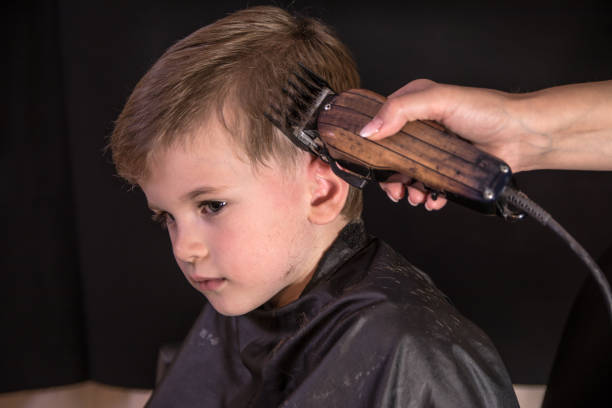 istock Child haircut with electric razor 1152578545