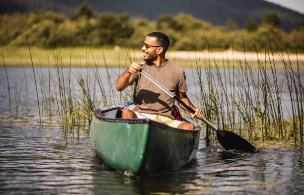 istock Young Man Canoening on the Lake 1152578836