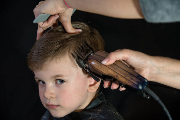 istock Beautiful Little Boy Getting a Haircut. Looking at camera 1152578944