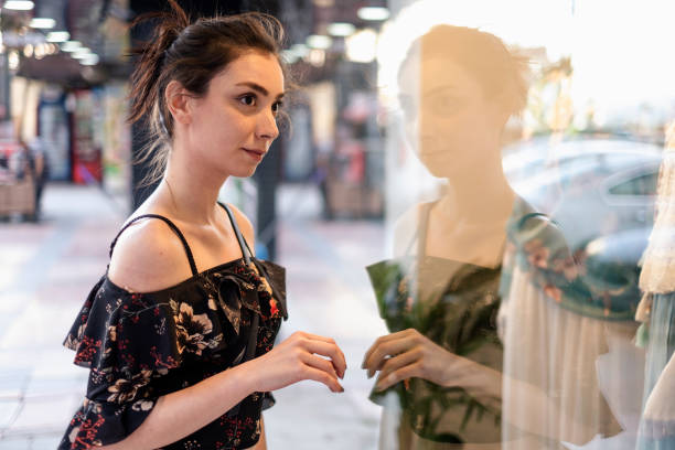 istock Young Lady Looking to a Store's Window 1152580442