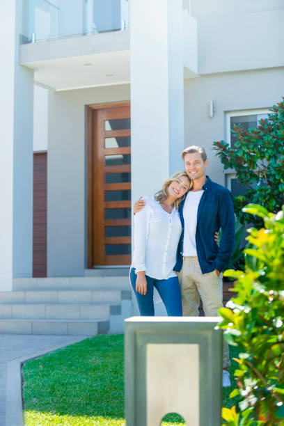 istock Couple standing in front of their new home. 1152580802
