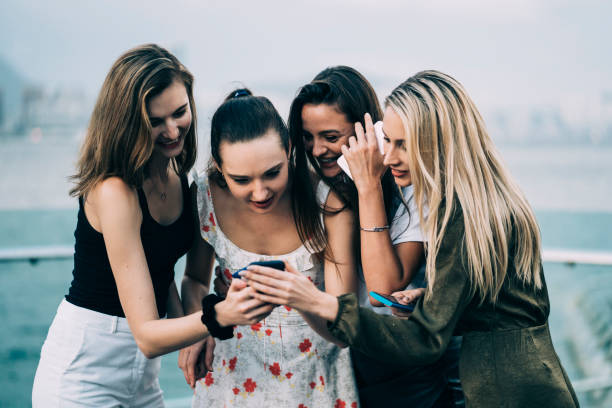istock Girlfriends having fun and social networking on street. 1152581326