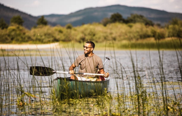 istock Young Man Canoening on the Lake 1152581414